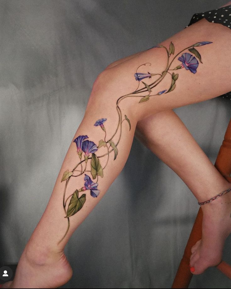 a woman's leg with flowers on it