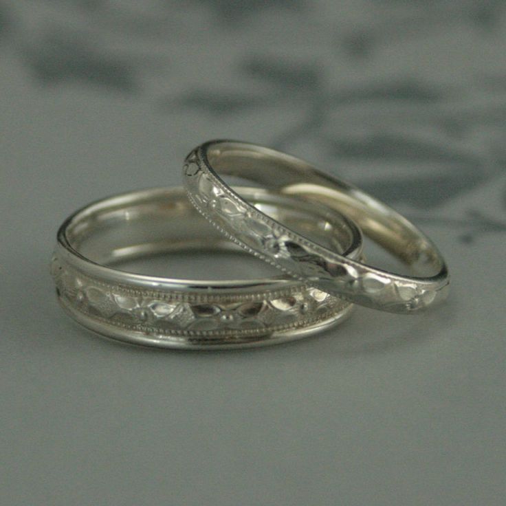 two wedding rings sitting on top of each other