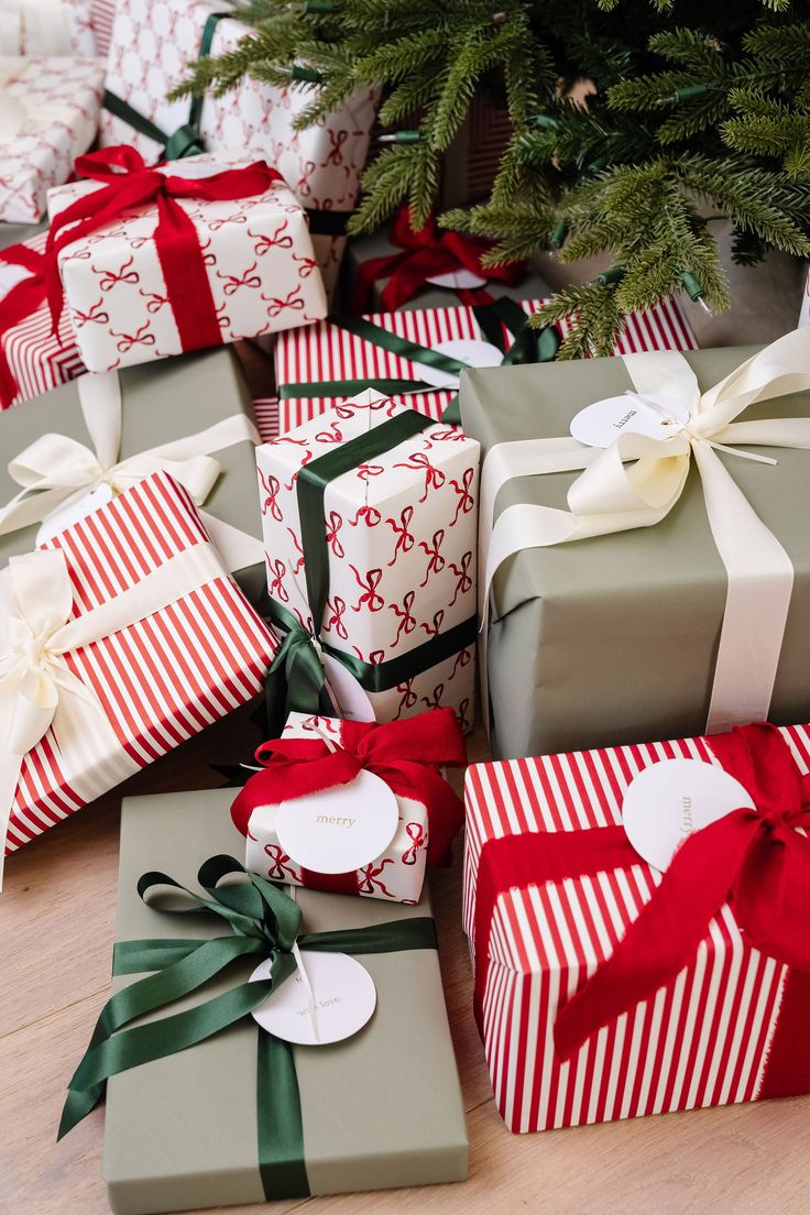 many wrapped presents under a christmas tree on the floor