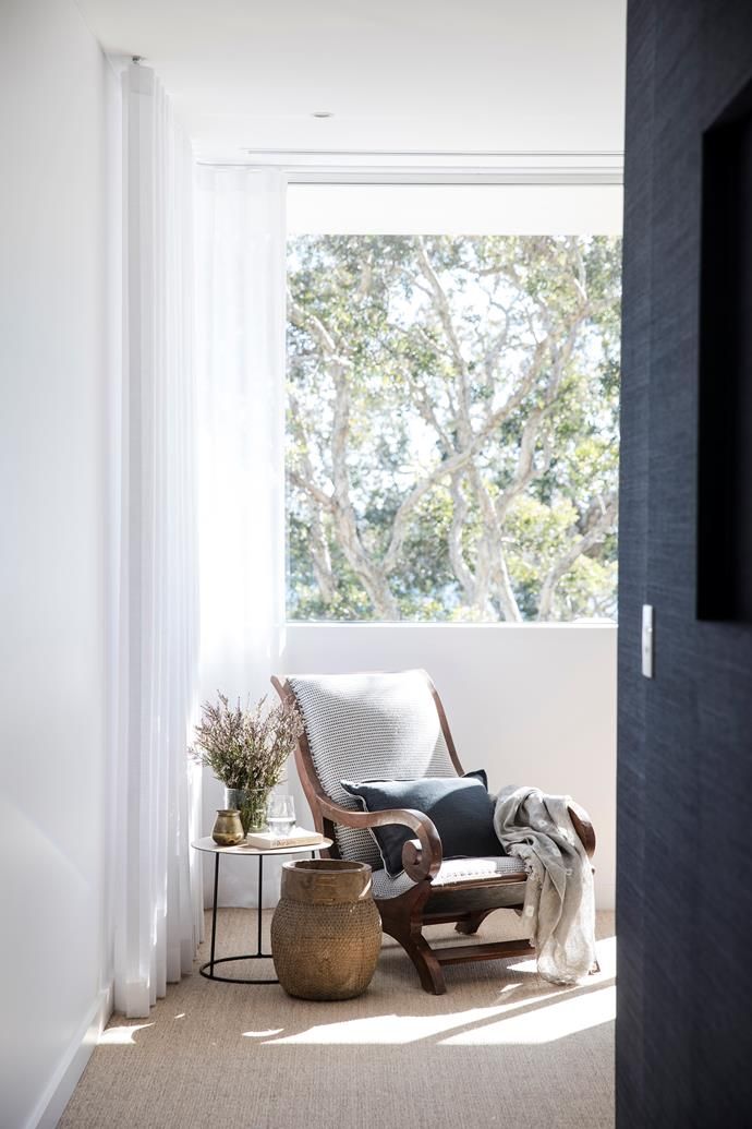 a living room with a chair and window