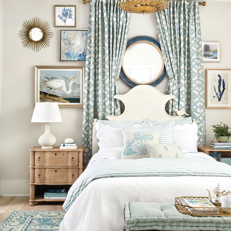 there is a bed with blue and white decor in the room, along with pictures on the wall