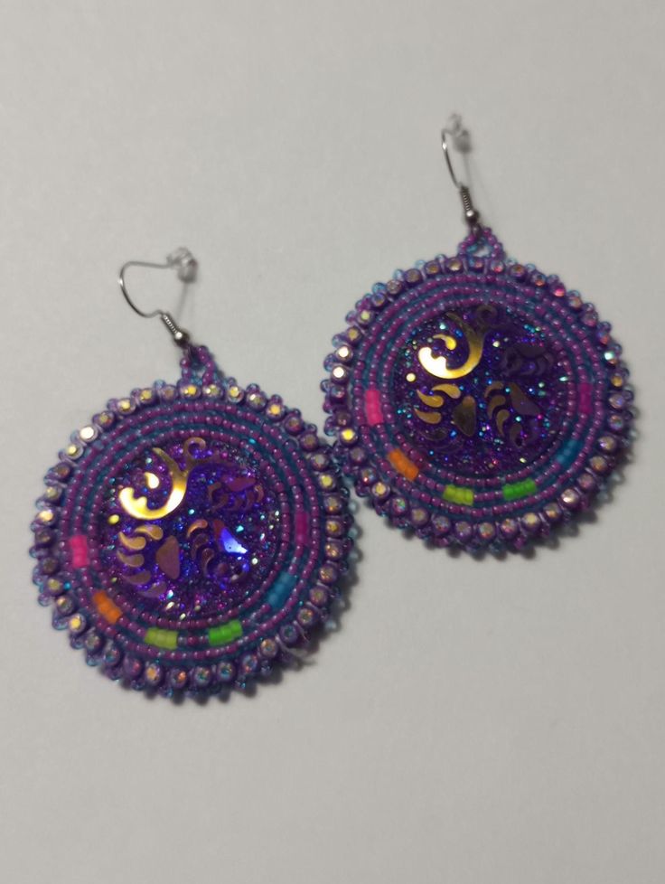 Hand-made beaded earrings: Colors: Purple w/neon colors  Closure: Hook size: 2 inches Handmade Round Beaded Earrings For Festivals, Purple Beaded Festival Earrings, Purple Beaded Earrings For Festival, Nickel Free Beaded Earrings For Festival, Purple Beaded Earrings With Round Beads For Festival, Nickel Free Round Beads Earrings For Festival, Festival Purple Beaded Earrings With Round Beads, Handmade Multicolor Beaded Earrings For Party, Purple Earrings With Colorful Beads For Crafting