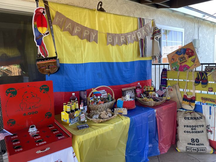 there are many items on display at this outdoor birthday party that is set up outside