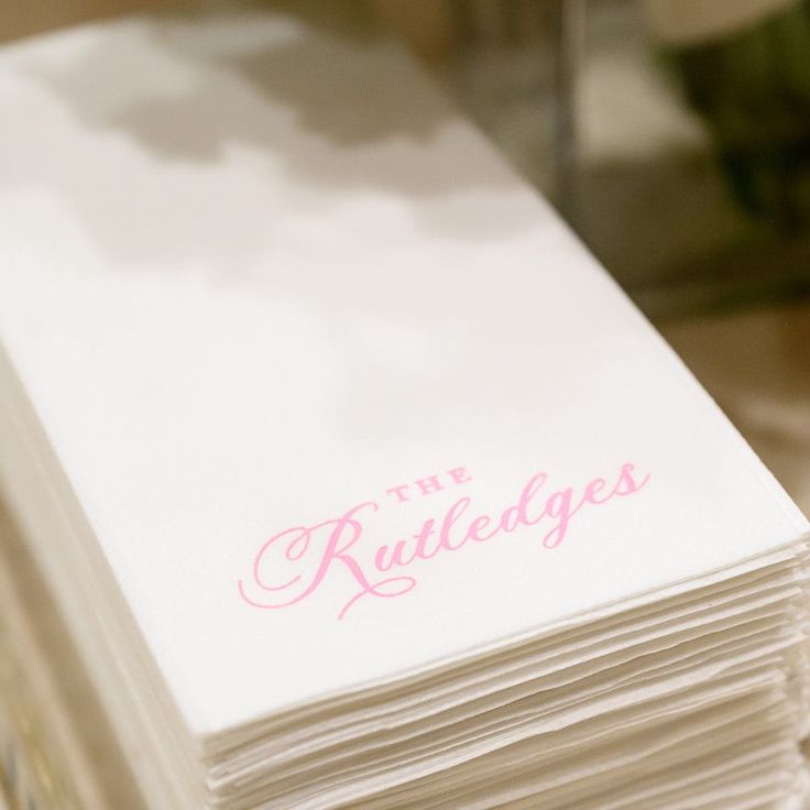 a stack of white paper with the words the ruttledges on it in pink ink