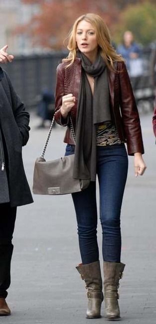 two women walking down the street with one carrying a handbag and another holding a purse