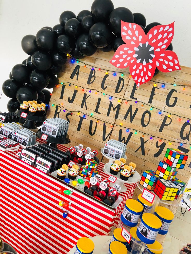 a birthday party with black balloons and decorations