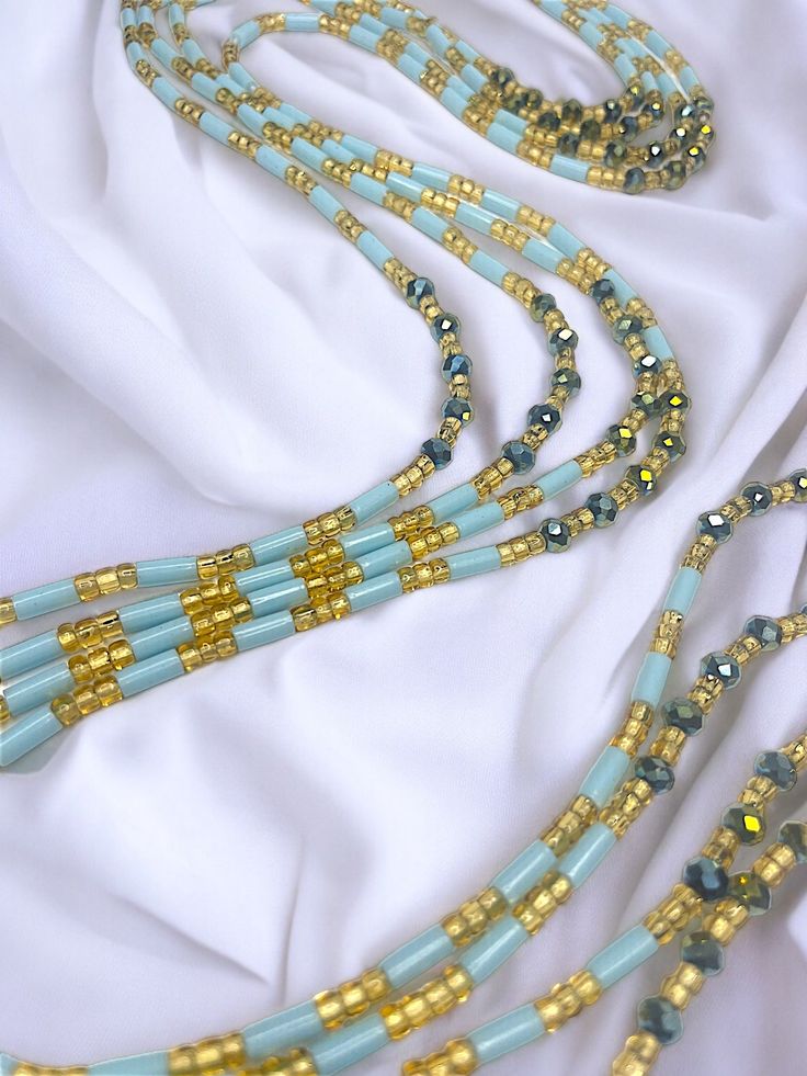 Single Strand Waist Bead Senoufo harmonizes the beauty of light blue crystal glass seed beads with the timeless elegance of gold glass seed beads. This handcrafted masterpiece captures the essence of sophistication, inviting you to adorn yourself with grace and style. 🌊 Light Blue Crystal Glass Seed Beads: Reflecting the tranquil hues of the sky and sea, the light blue beads exude calm and serenity. Blue signifies wisdom and clarity, empowering you with a sense of purpose. 🌟 Gold Glass Seed Be Strong Hand, Natural Glow, Gold Glass, Blue Crystals, Blue Beads, Gold Beads, Design Crafts, Timeless Elegance, Seed Beads