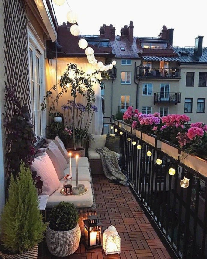 a balcony with lots of plants and lights