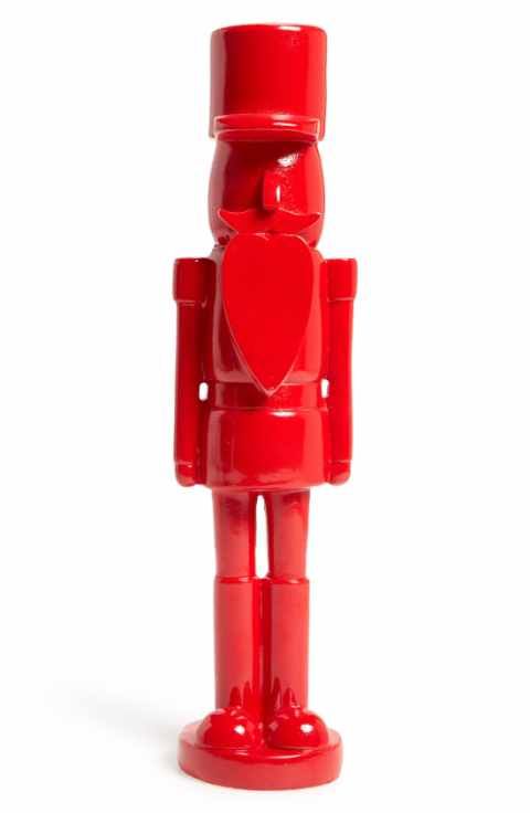 a red plastic toy figure with a heart on it's chest and arms, standing in front of a white background