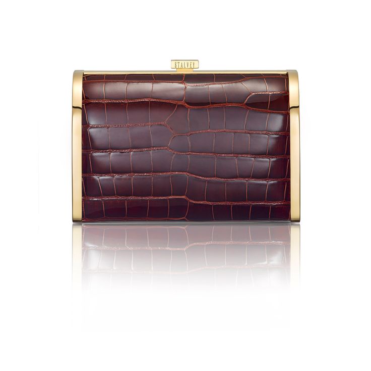 A new silhouette from STALVEY's signature collection, the Rounded Clutch is an evening clutch with alligator or lizard skin, perfectly placed within a palladium or 24kt gold hardware frame. A rounded curvature at the top front of the clutch provides an elegant feel. Square push pin opens the clutch up to a spacious leather-lined interior. Two custom STALVEY twist screws on either side of the chain provides an adjustable shoulder strap drop height, perfect for transitioning from daytime wear to e Formal Rectangular Clutch With Palladium Hardware, Luxury Rectangular Clutch, Classic Formal Clutch With Palladium Hardware, Elegant Formal Clutch With Crocodile Pattern, Elegant Evening Clutch With Crocodile Pattern, Formal Leather Clutch With Crocodile Pattern, Elegant Rectangular Clutch With Crocodile Pattern, Elegant Rectangular Crocodile Pattern Clutch, Formal Compact Leather Clutch