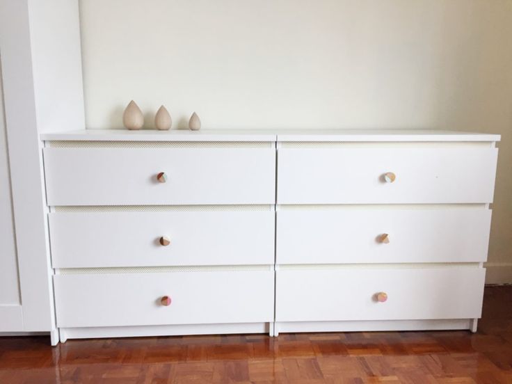 a white dresser sitting on top of a hard wood floor