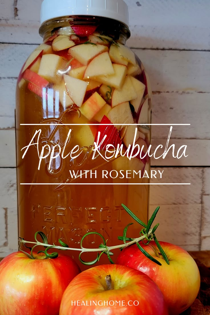 an apple kombucha with rosemary in a jar and apples on the table