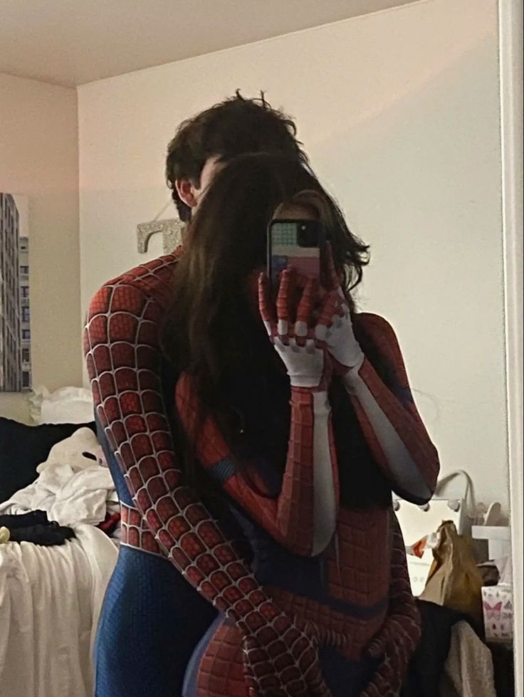 a woman in a spider suit taking a selfie