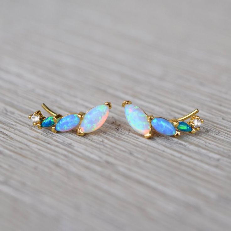 -18kt gold vermeil -lab created blue opal ombre stones  Earrings with a unique twist. These gorgeous colorful ear climbers are dainty but they are also striking and eye-catching. Made up of a mix of pastel colored opal hues. To extend the life of your gold plated and vermeil jewelry, avoid wearing when washing hands, showering, applying lotion, using harsh cleaning supplies or working out. To clean, buff gently with a soft and dry 100% cotton cloth or a microfiber cloth. Do not use jewelry cleaner on gold plated jewelry. Tennis Jewelry, Stones Earrings, Solid Gold Necklace, Ear Climbers, Solid Gold Earrings, Forever Jewelry, Vermeil Jewelry, Jewelry Ring Box, Blue Ombre