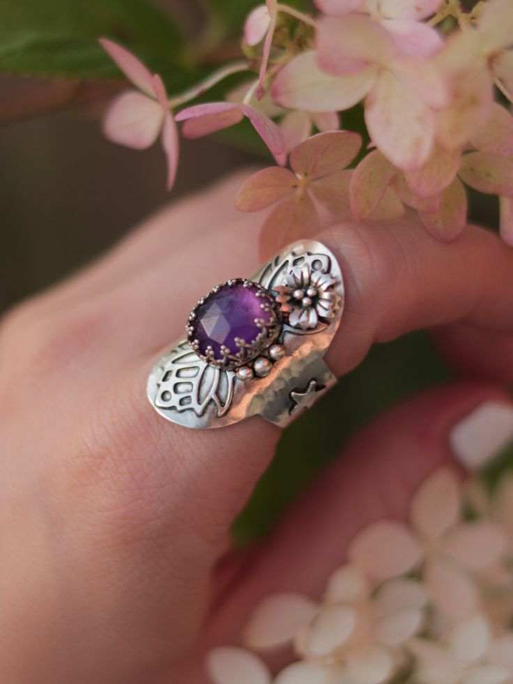 This magical shield ring was designed to protect you from evil and make you feel confident and happy in your skin. Entirely handcrafted in sterling silver, this ring features a lovely faceted amethyst gemstone and handmade embellishments. Size 6.5, but due to its wide band, the ring will comfortably fit size 6. You can see how this ring was made in this video: ➥ All Stardust Mine products are made by hand of a real person and not machine, using precious and semi-precious metals and natural stone Magical Shield, Handmade Embellishments, Shield Ring, Wide Bands, Amethyst Gemstone, Stardust, Feel Confident, Precious Metals, Your Skin