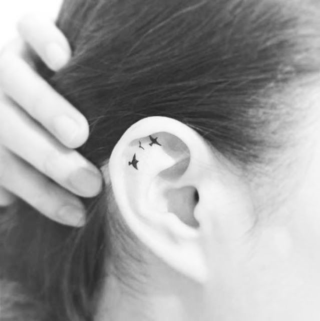 a woman's ear with stars on it