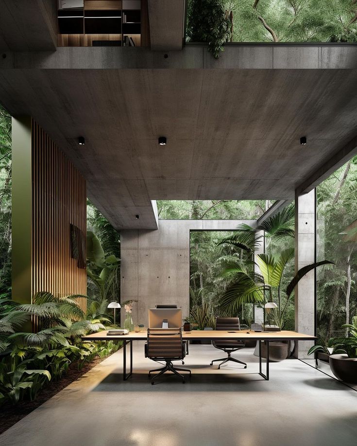 an office area with desks and chairs in the middle of it, surrounded by greenery