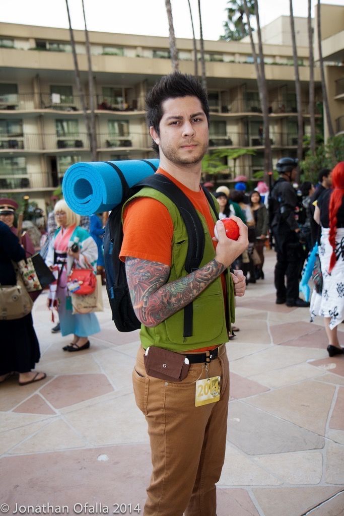 a man with a backpack and an apple in his hand is holding a large blue tube