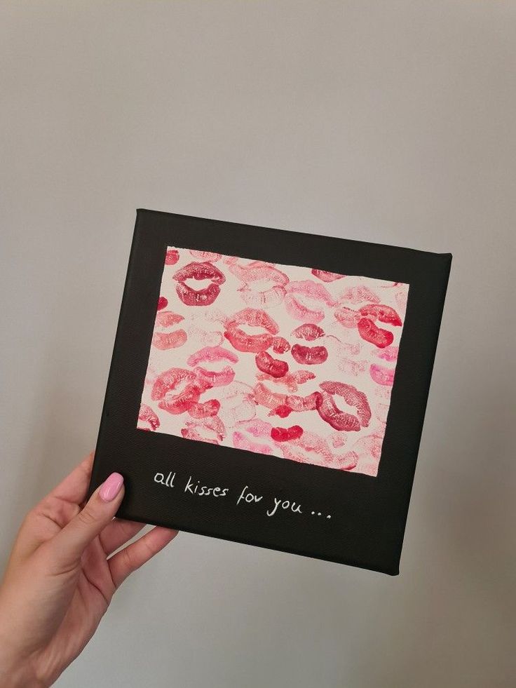 a hand holding up a card with lipstick on it that says, all kisses for you