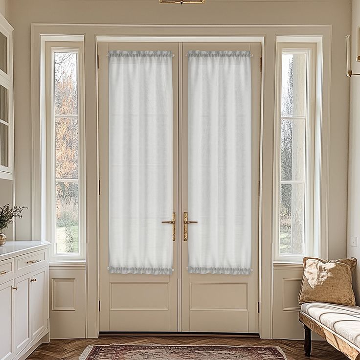 a large white door with two windows and a rug on the floor in front of it