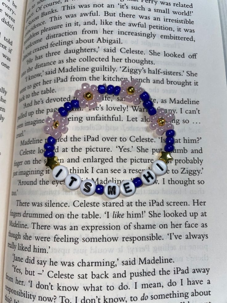 an open book with a beaded bracelet that says, i am not afraid to read