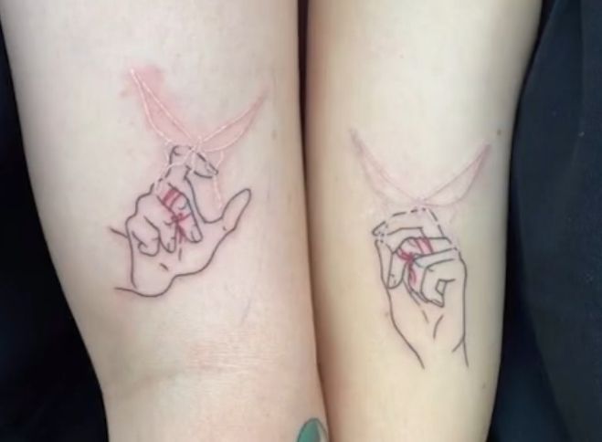 two people with matching tattoos on their arms