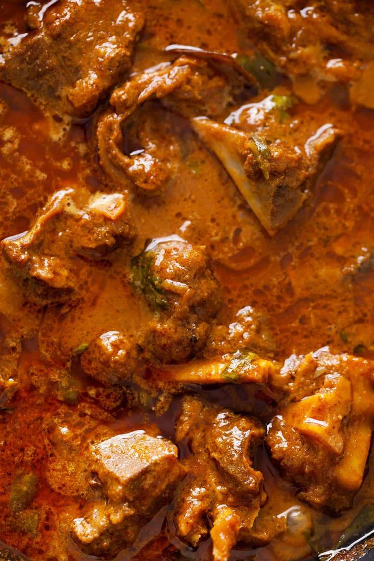 meat and vegetable stew in a pan with a spoon on the side, ready to be eaten