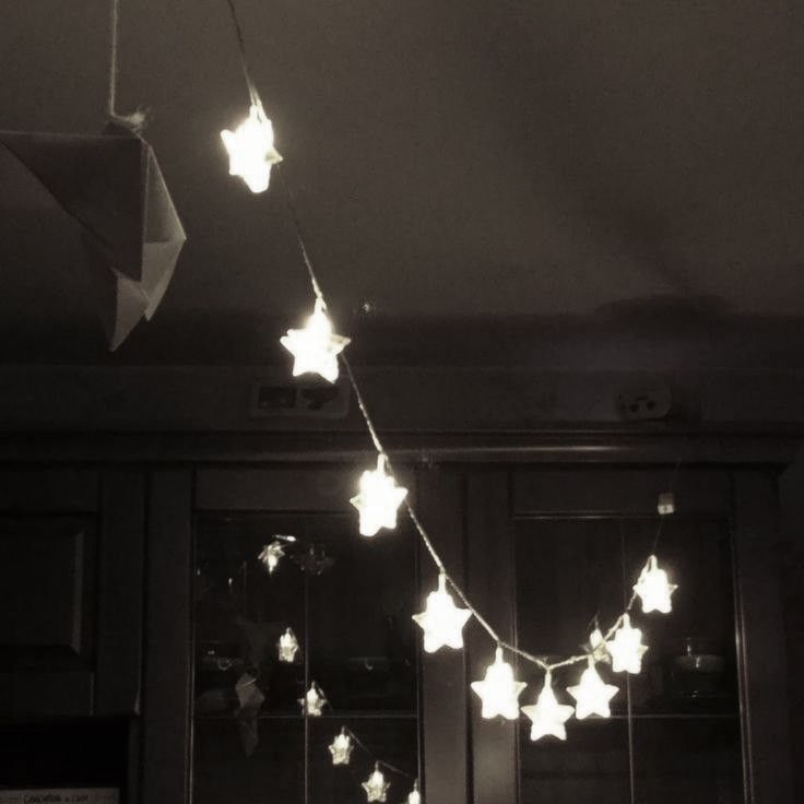 some white stars are hanging from the ceiling