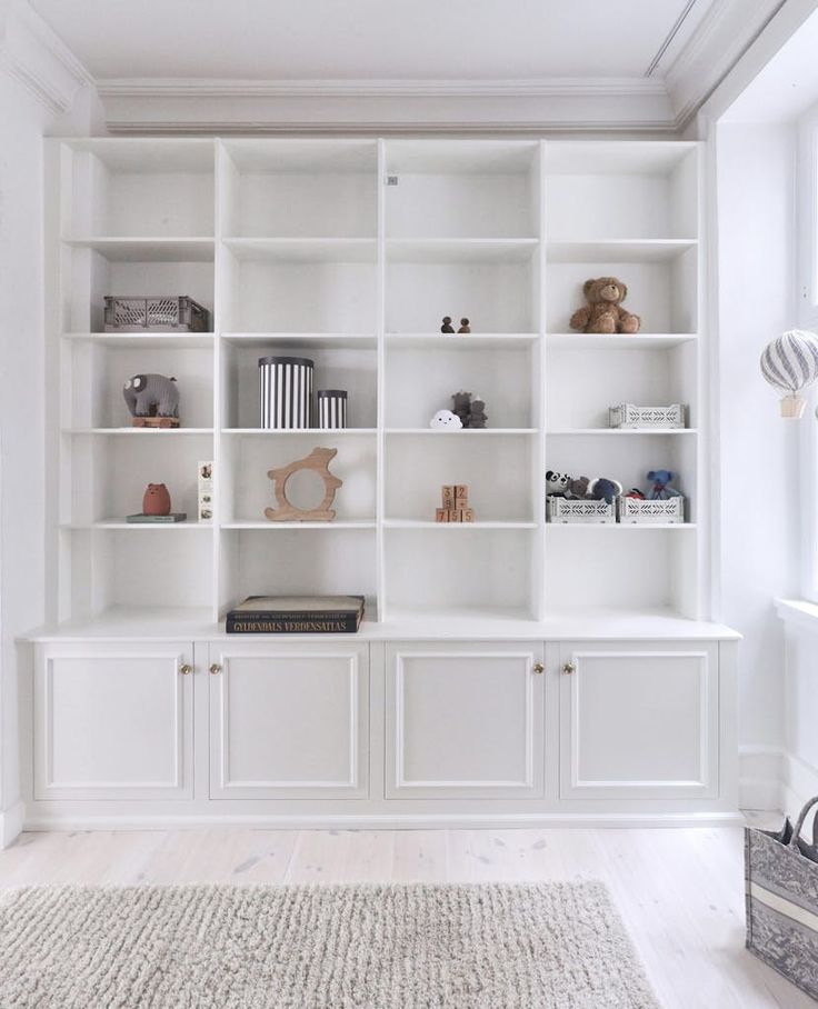 a white bookcase filled with lots of books