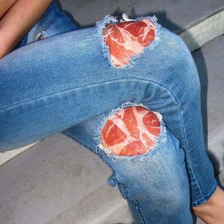 two pieces of meat that have been cut in half sitting on someone's legs