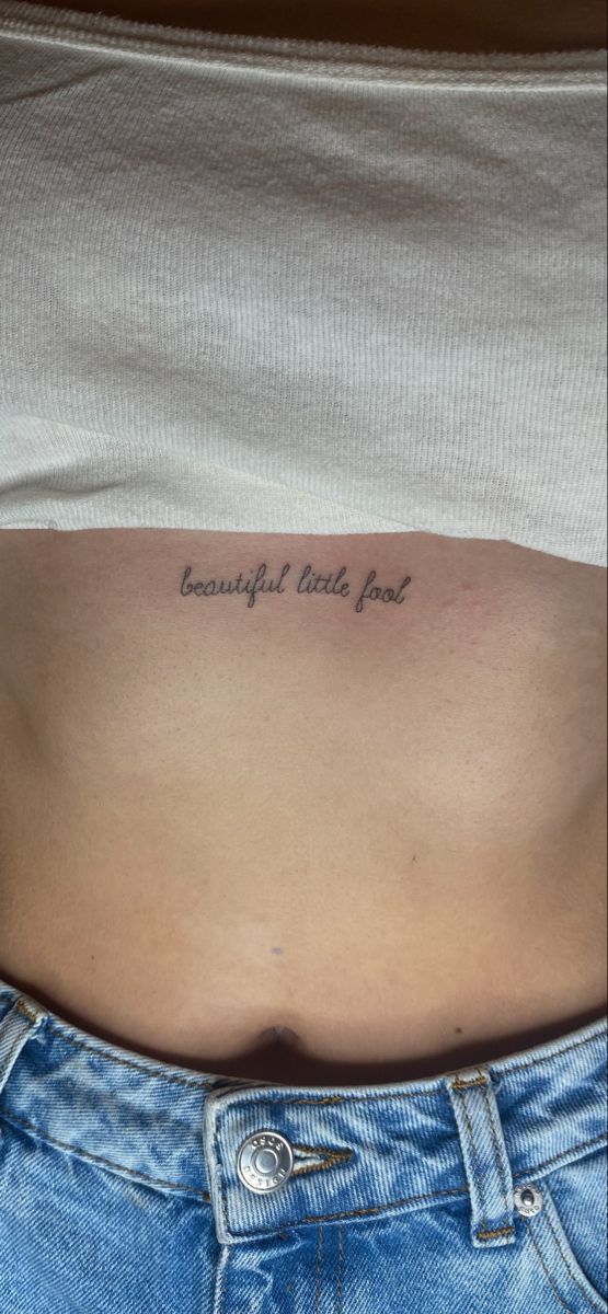 a woman's stomach with the words beautiful tattoos on her belly and an inscription above it