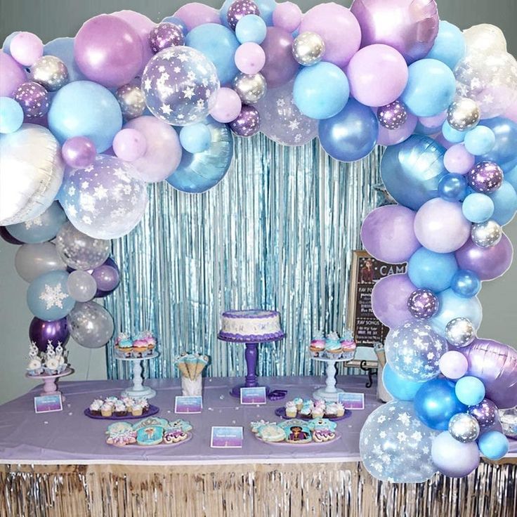 a table topped with balloons and cake