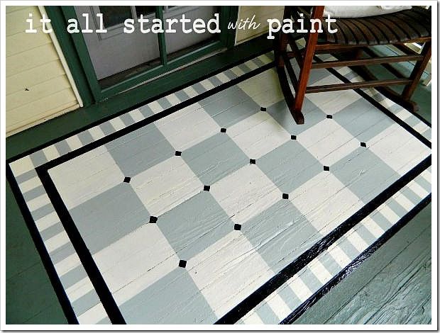 a black and white checkered rug on the floor next to a wooden chair with a green door