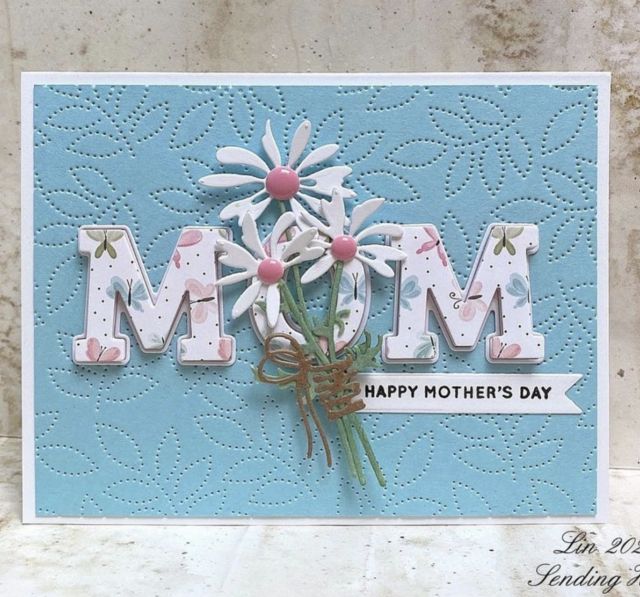 a mother's day card with daisies and the word mom