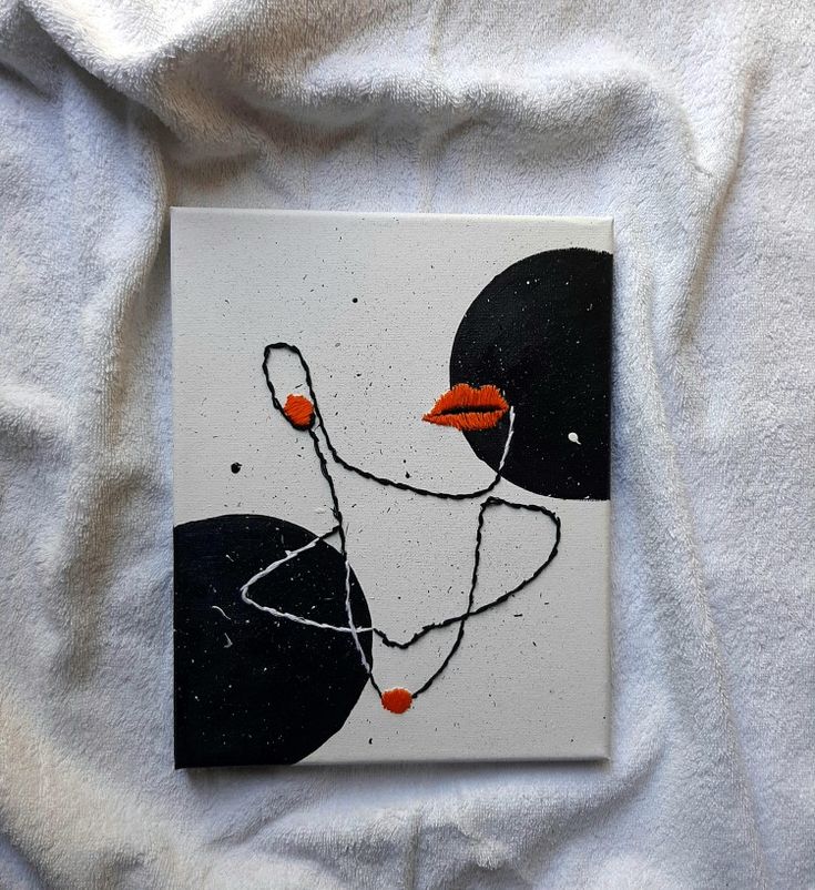 a white towel with a black and orange painting on it