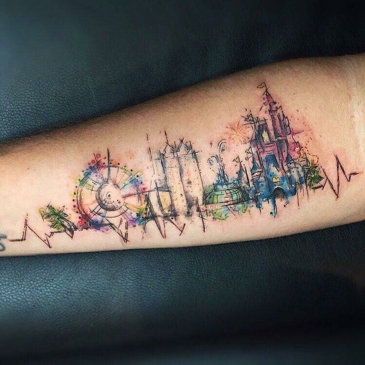 a tattoo with the word disney written in watercolor on it's left arm