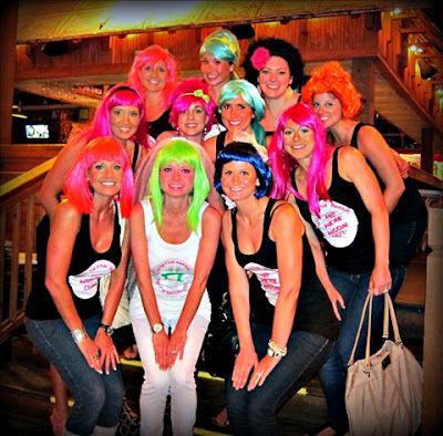 a group of women with colorful hair posing for a photo