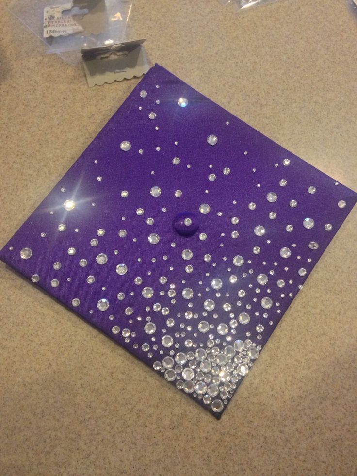 a purple and silver square with lots of small bubbles on the top, sitting on a table