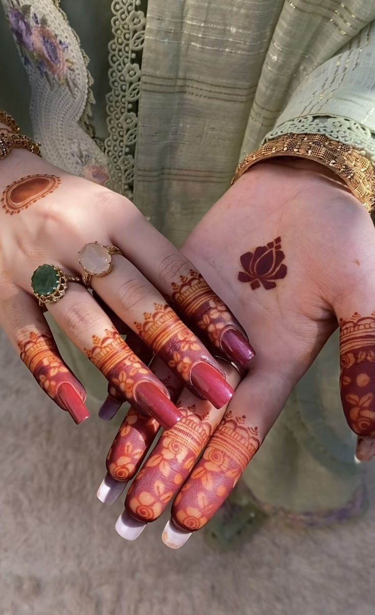 two hands with henna designs on them