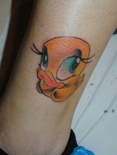 a cartoon character tattoo on the ankle