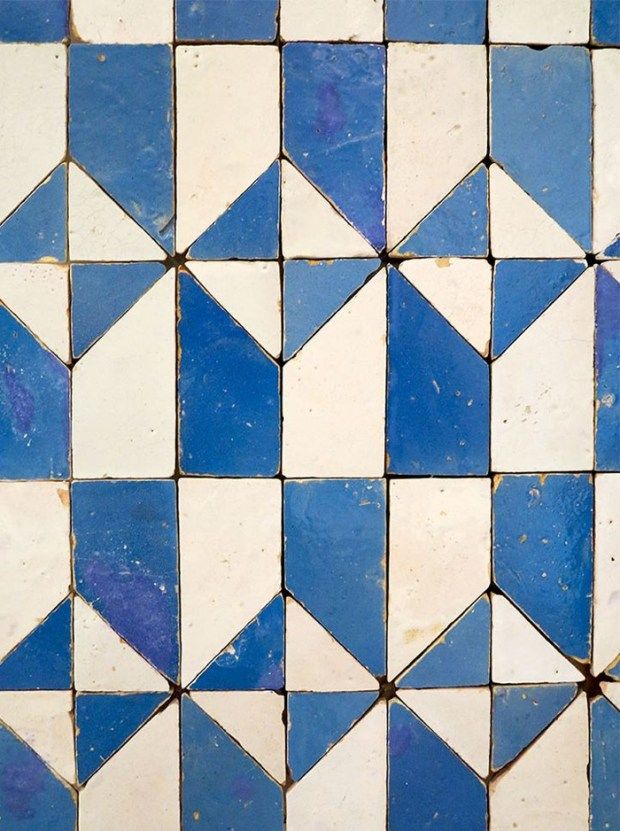 a blue and white tiled floor with small triangles