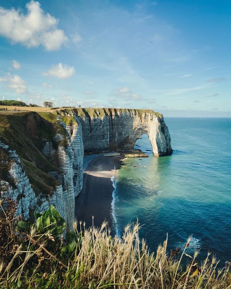 an image of the ocean and cliffs that look like they have been carved into something