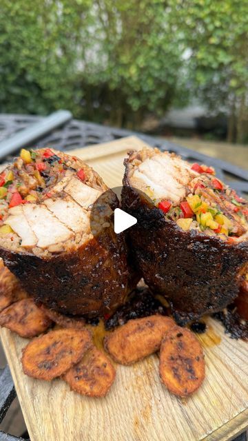 two pieces of meat sitting on top of a wooden cutting board