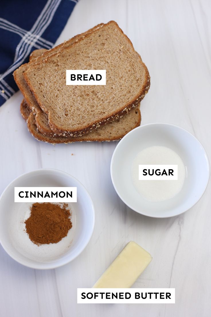 bread, butter, and other ingredients are shown on a white wooden surface with words describing the different types of bread