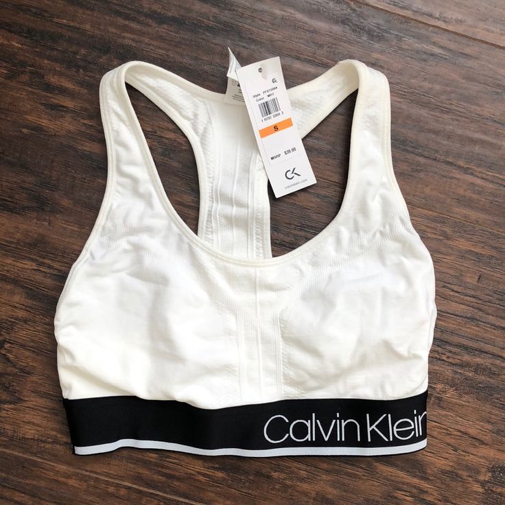 Never Worn Calvin Klein Performance Sports Bra. White Racer Back With Black Band. Super Soft! Comes From A Smoke Free, Pet Free Home. Price Is Firm. Calvin Klein Stretch Activewear For Yoga, Calvin Klein Athleisure Activewear For Yoga, Calvin Klein Medium Support Sports Bra For Workout, Supportive Calvin Klein Activewear For Workout, Sporty Activewear With Logo Waistband, Sporty Activewear With Logo Waistband For Sports, Calvin Klein Fitted Sports Bra For Athleisure, Calvin Klein Fitted Athleisure Sports Bra, Calvin Klein Sporty Activewear With Medium Support