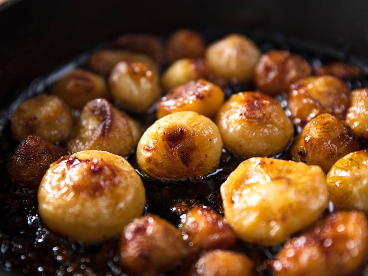 some food is cooking in a pan on top of the stove and it looks like they have been cooked