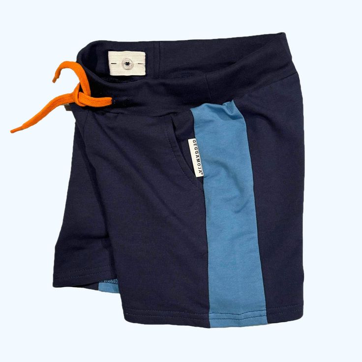 Geggamoja® of Sweden These soft, comfy shorts will become a favorite! Made of 95% organic cotton with 5% Lycra for stretch and ease of movement. Made of 95% Organic Cotton/5% Lycra Inner, adjustable elastic waistband. Sewn-in orange ties in front waistline. 2 front pockets, 1 back pocket. Machine wash, warm. (40 C°/ 104° F) Sizes (European size is based on child's full height in centimeters - see below) 86/92 (1-2 yr.) 98/104 (3-4 yr) Conversion to height in inches 86/92 = 33.5 / 36.5 inches 98/ Playful Blue Bottoms With Built-in Shorts, Cotton Shorts For Playtime, Cotton Playtime Shorts, Navy Cotton Sports Shorts, Blue Cotton Pajama Shorts With Relaxed Fit, Blue Relaxed Fit Cotton Pajama Shorts, Blue Cotton Relaxed Fit Pajama Shorts, Casual Short Length Bottoms For Playtime, Organic Cotton Shorts For Everyday Summer Wear