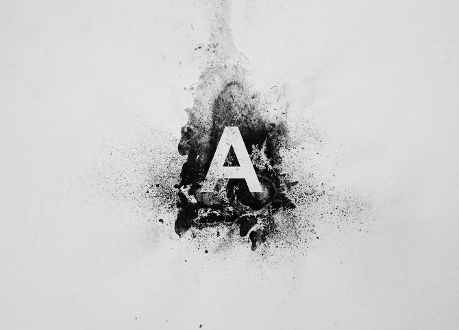 the letter a is made up of black and white ink splatters on paper