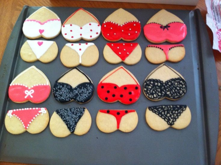 decorated cookies in the shape of bikinis and bras on a cookie sheet, ready to be eaten