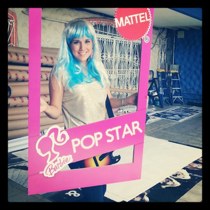 a woman with blue hair is holding a pop star sign